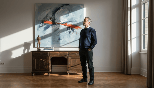 Collector admiring contemporary art in home
