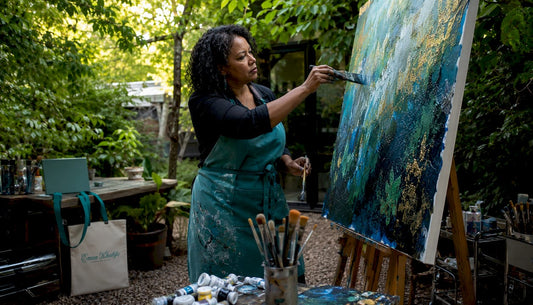 Contemporary artist mixing paint in bright studio