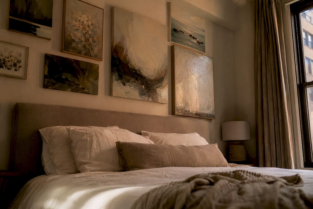 Layered bedroom wall art above bed