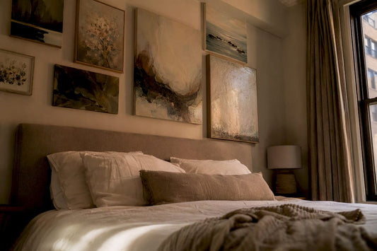 Layered bedroom wall art above bed