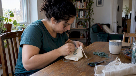 Woman embroidering a small handmade gift