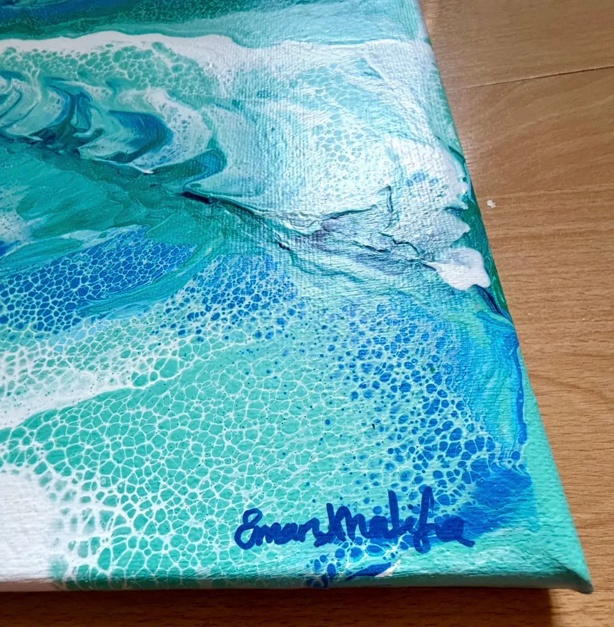 Artistic depiction of ocean waves on a textured surface with 'Eman Khalifa' signature.