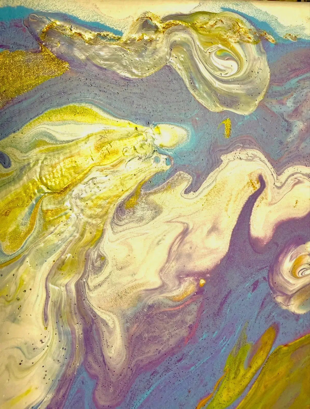 Abstract art with swirling gold, blue, and beige colors