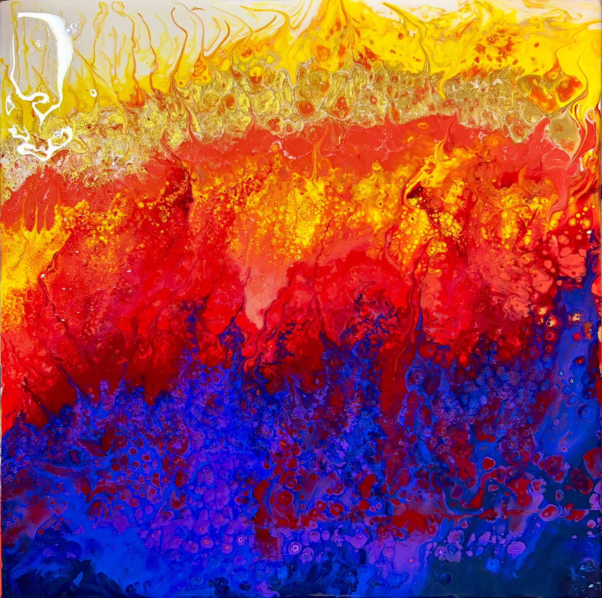 Abstract fluid acrylic pour painting with vibrant horizontal bands of yellow, orange, red, and deep blue, featuring textured splatters and marbled patterns.