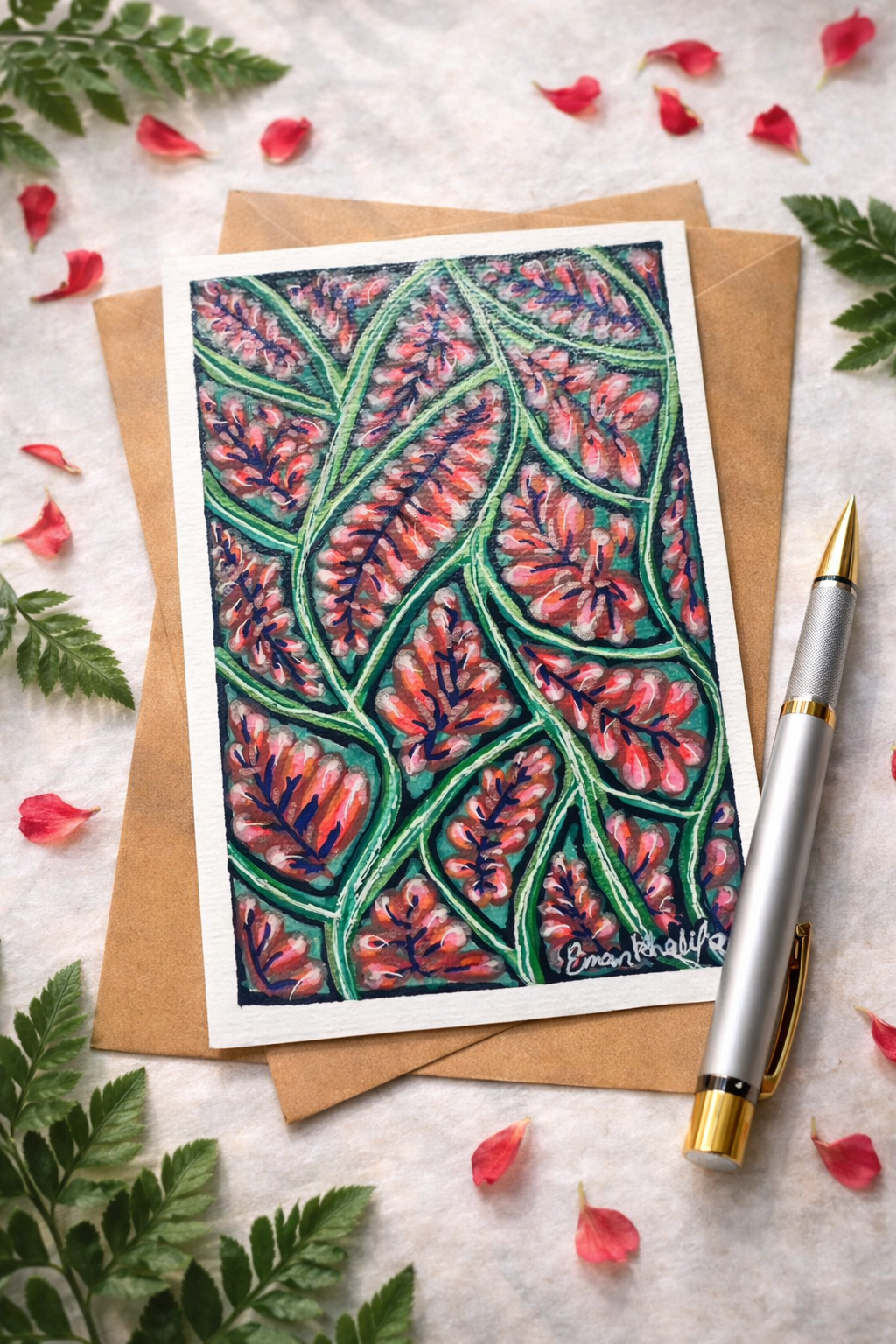 A6 original acrylic painting featuring a vibrant floral bloom pattern with red blossoms and green botanical lines by Eman Khalifa, on a textured surface with pen, envelope and leaves.