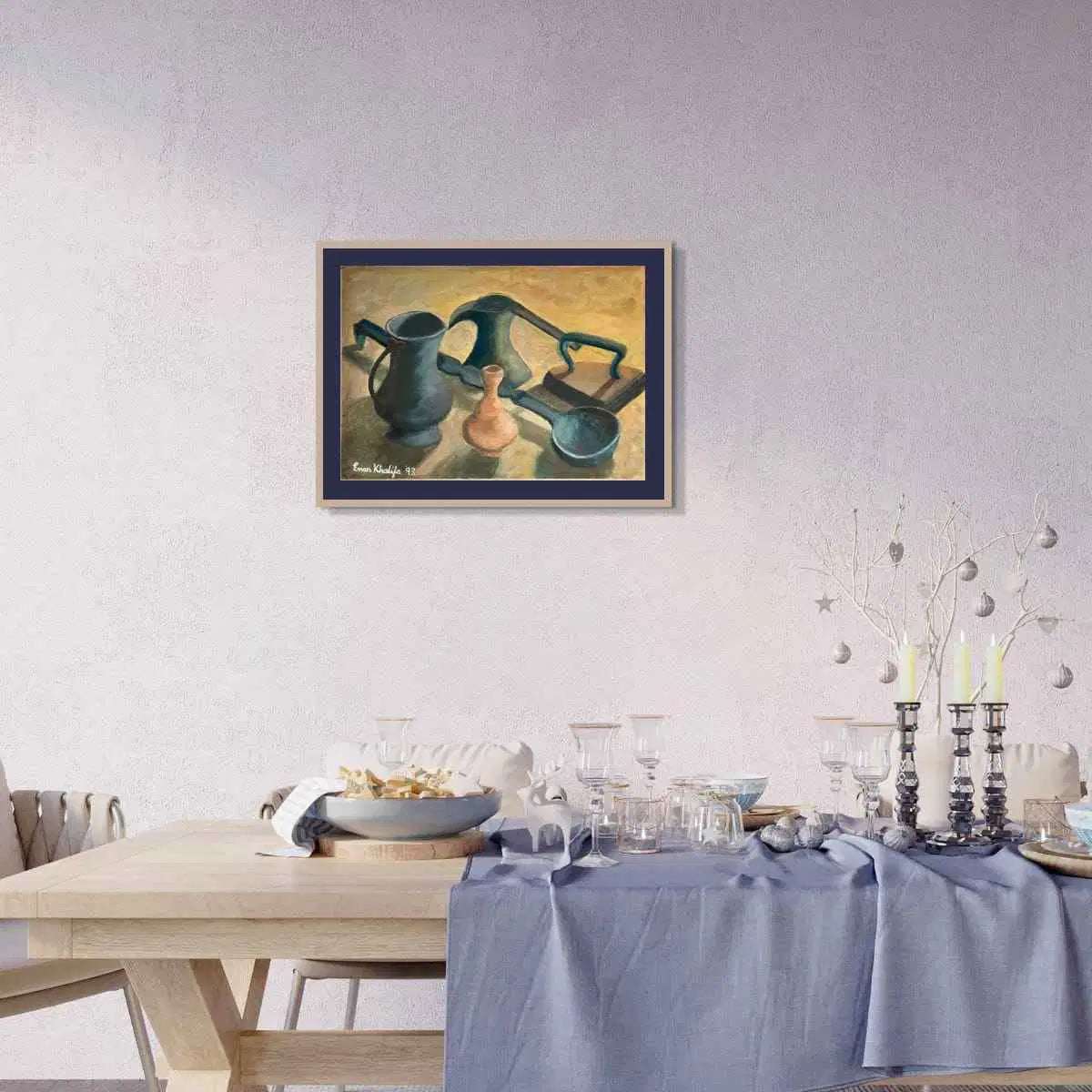 Dining room with a table set for a meal, framed artwork on the wall, and decorative elements.