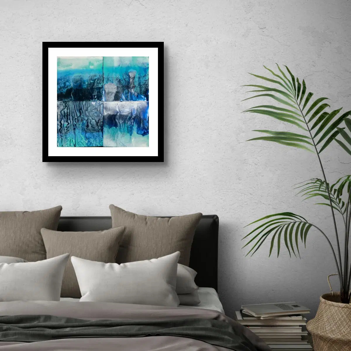 Framed Abstract blue quadriptych painting above grey sofa inspired by glacial drift and oceanic flow, with layered textures and cool tones