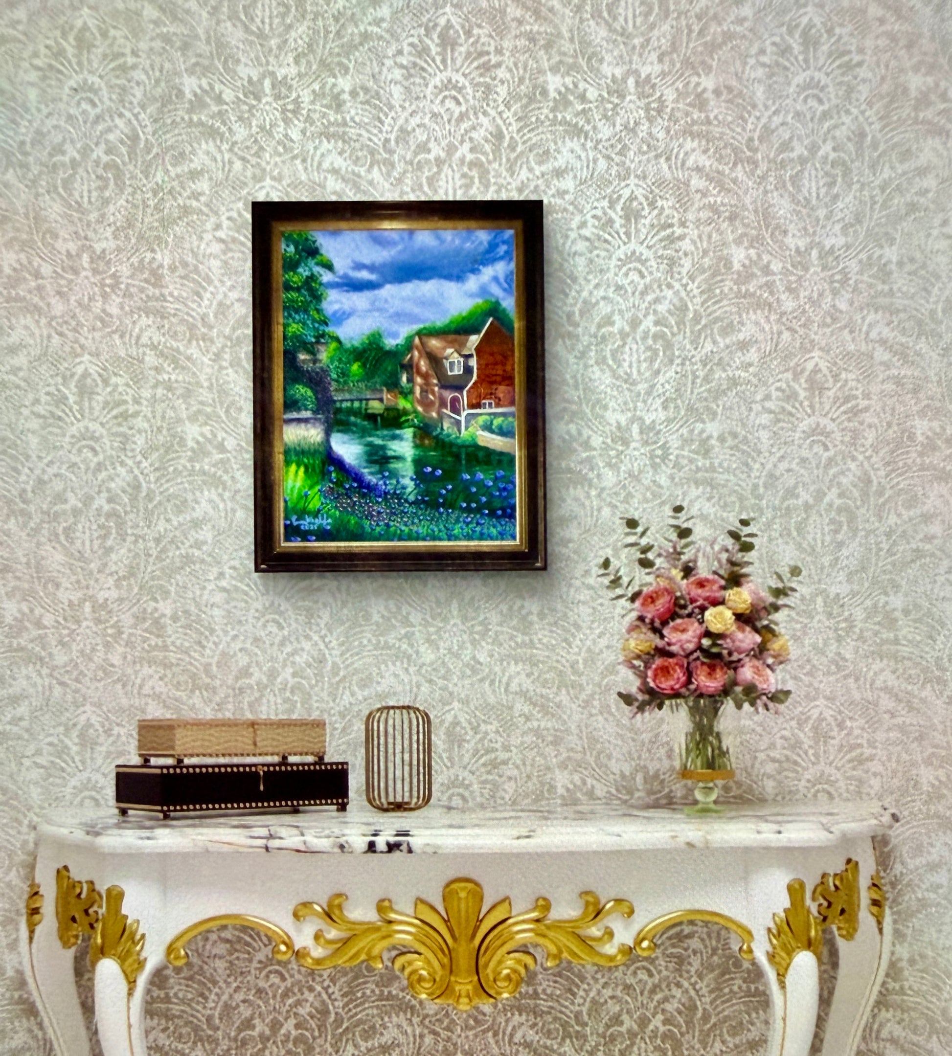 Framed painting on a wall above a decorative console table with a vase of flowers.