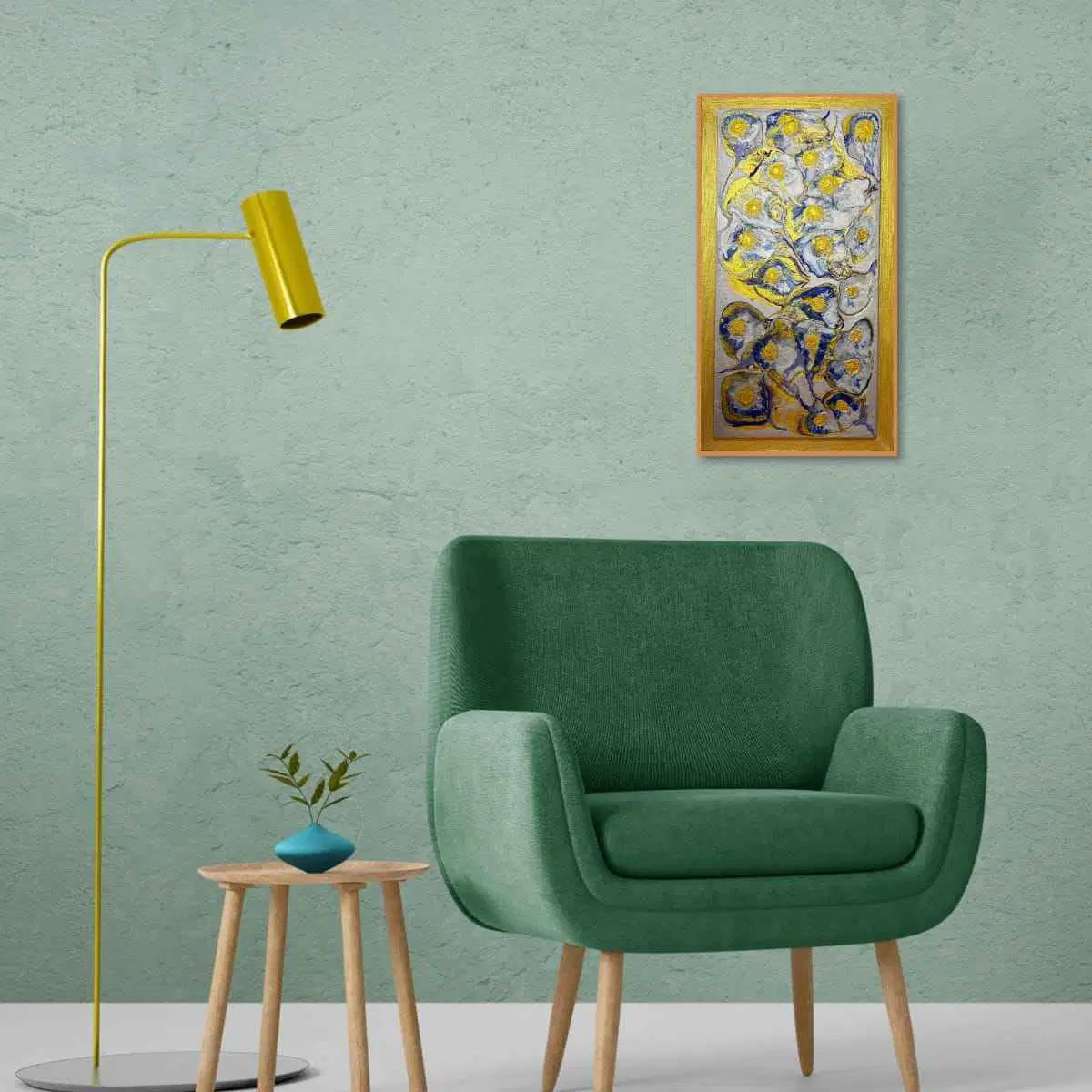 Modern green armchair in a room with a yellow floor lamp, small table, and abstract painting on a green wall.