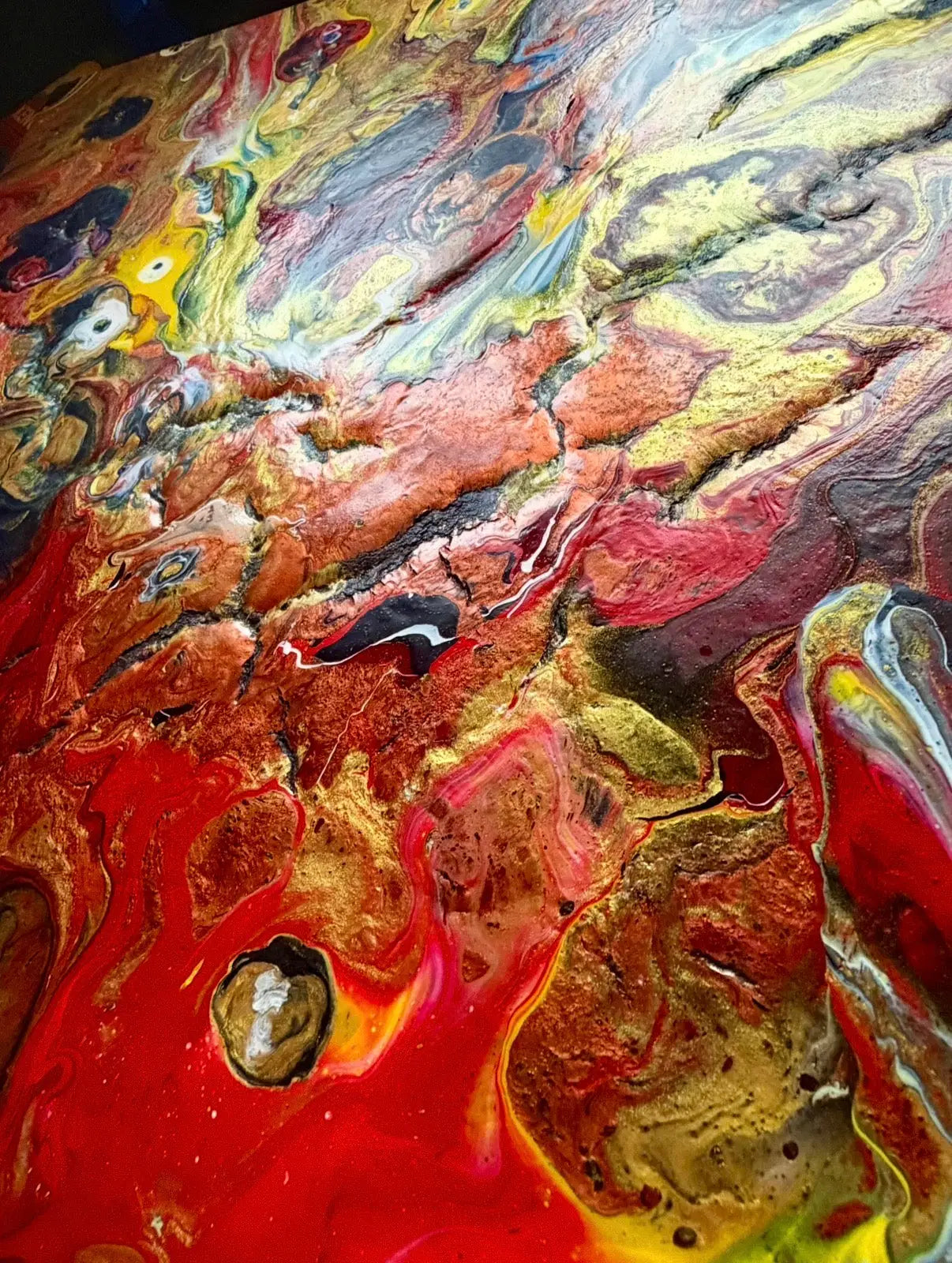 Abstract art with swirling colors of red, yellow, and gold.