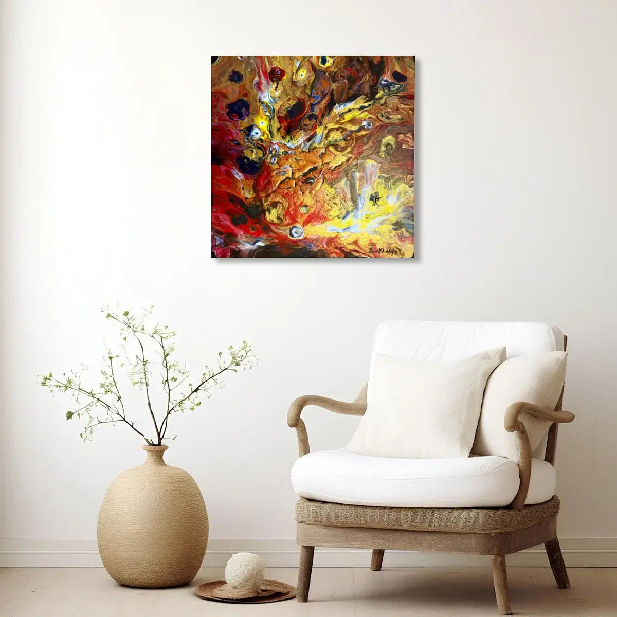 White armchair with a vase and abstract fire painting on a white wall